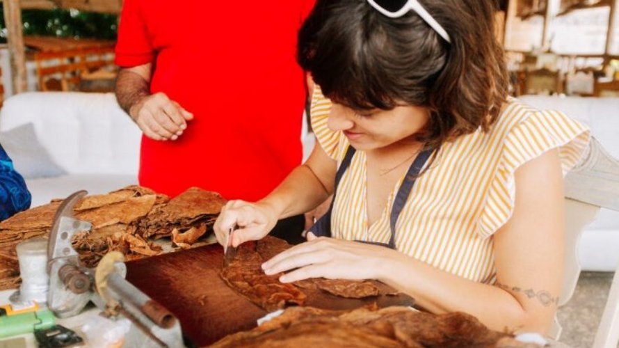 woman learning to roll cigars in a Havana workshop